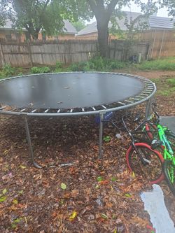 Trampoline roughly 14 feet comes with 2 kids bikes