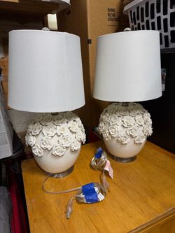 ceramic table lamps featuring an array of sculpted, dimensional 3D rose appliqués covering the rounded bases and topped with classic white drum shades