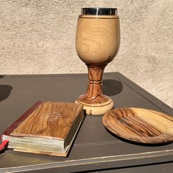 handmade olive wood communion chalice and a matching wooden paten (plate) crafted in the Holy Land.