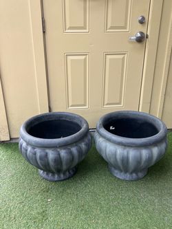 The selected item is a low, fluted plastic urn planter featuring a wide, rounded bulbous body and a short pedestal base. Depending on the brand, retai