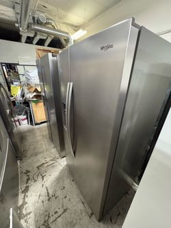 Whirlpool side-by-side refrigerator with Ice Maker, water, and ice dispenser
