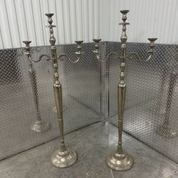 Pair of silver toned 3 arm candelabras located near the Miami Design District that measure 60” h x 22.5” w x 12” d.