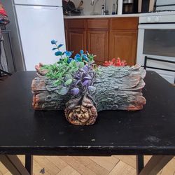 Decorative sunken barrel / shipwreck-style aquarium decoration with artificial plants. 