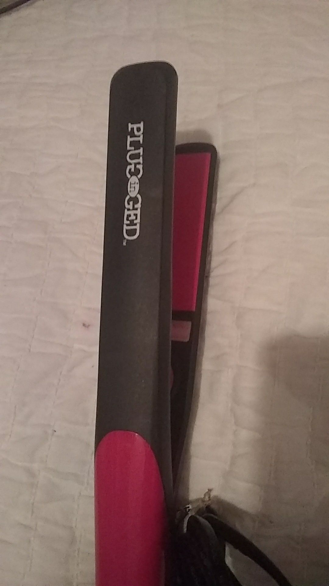 Plugged in hair straightener
