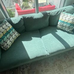 Teal Couch With Two Pillows