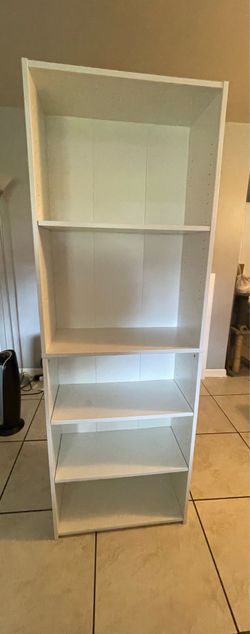 Tall white wooden shelving unit
