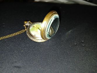 This is a Quartz Men Pocket Watch with a map design and a gold stainless steel 14-inch chain. 