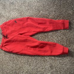 Red Nike tech pants. Size M