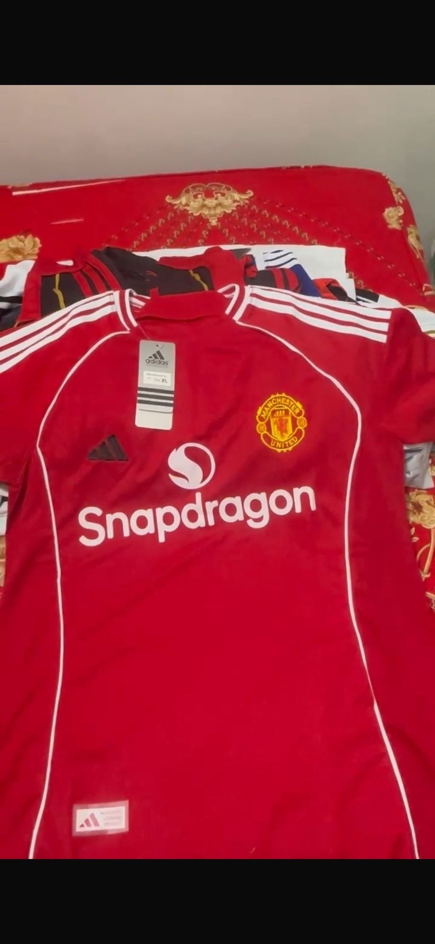 This is an Adidas Real Madrid jersey featuring the Emirates Fly Better sponsor. It has the classic Adidas stripes on the sleeves and the Real Madrid c