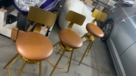 Set of three copper colored barstools.