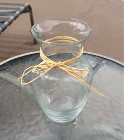 Large glass vase with flared rim & raffia bow