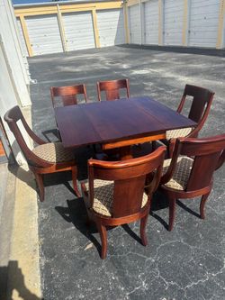 Solid oak wood dining table with six chairs & pedestal base and drop leaf.. 48 “ wide, 44l depth , 30 “ high … $600