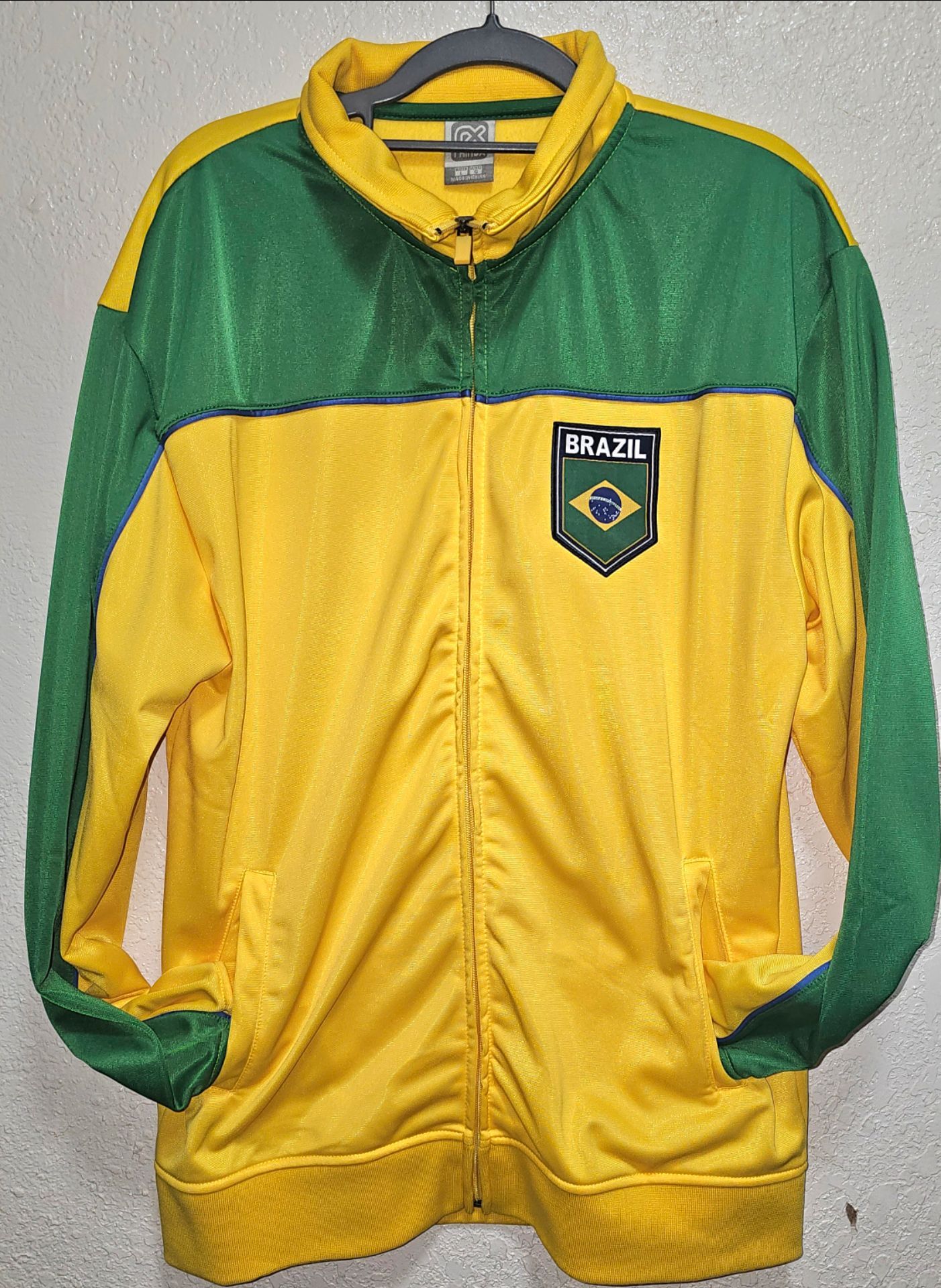Vibrant G3 Brazil full zip track jacket. Jacket has green and yellow colors. It has a 'BRAZIL' patch on chest with Brazilian flag design. Size is larg