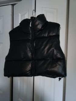 Black Faux- Leather puffer vest featuring a high mock neckline and a full front zipper. Size L
