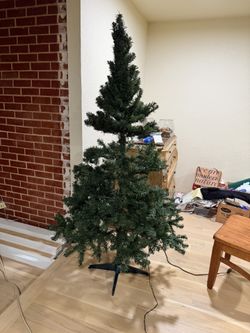CHRISTMAS TREE, 6'; I half fixed the branches to show what it looks like, LIGHTS DO NOT WORK; cross streets are Arapaho & Waterview