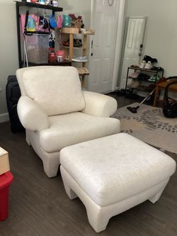 Cream colored chair and matching hassock