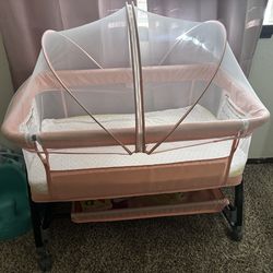 Pink bassinet with mesh cover
