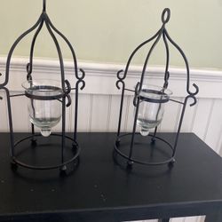 Black metal candle holders with hanging glass cup.