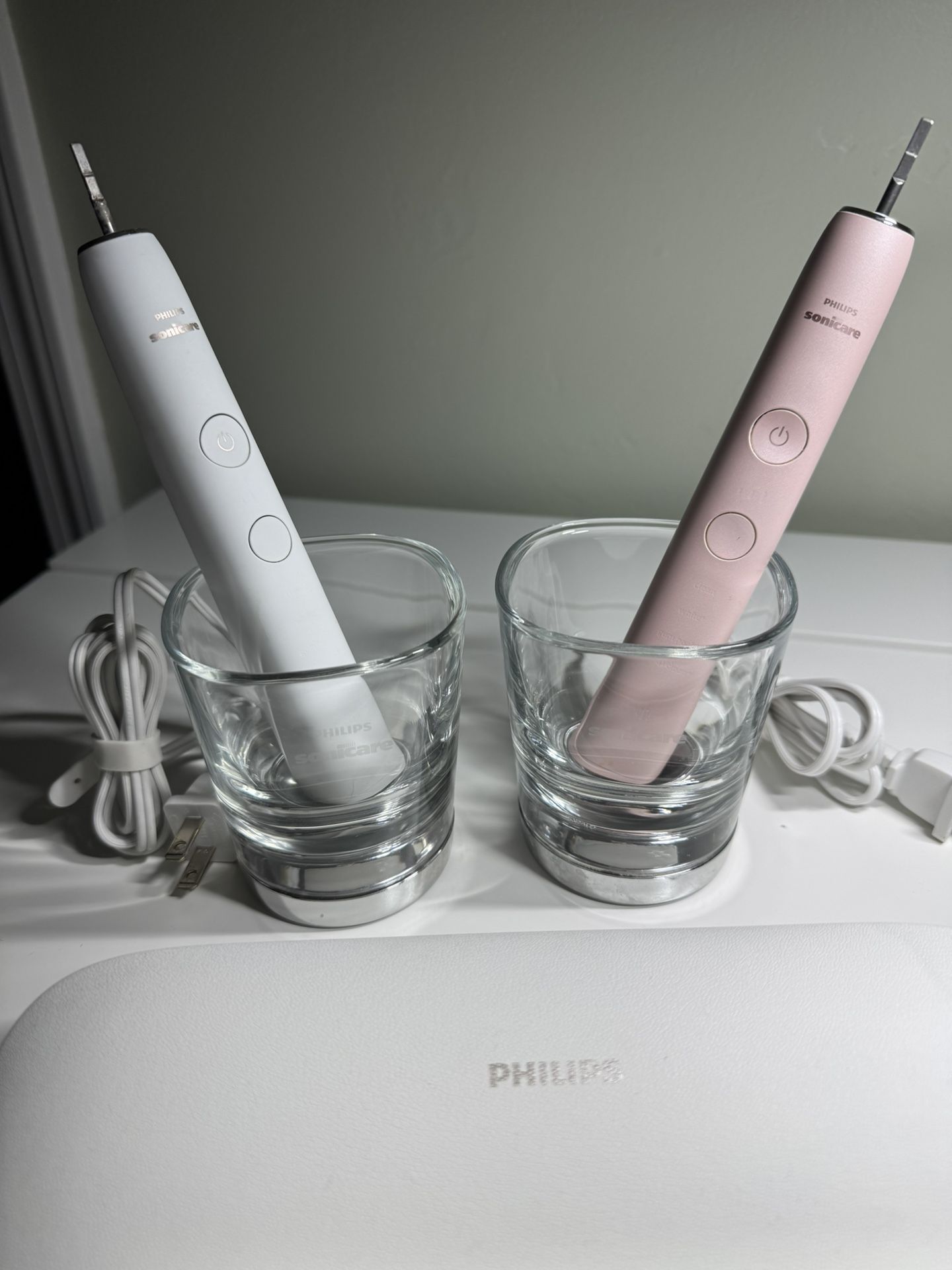 2 Philips Sonicare Electric Toothbrushes – With Travel Cases & Charging Glasses