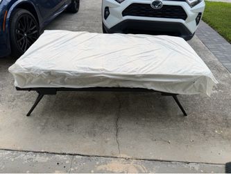 Twin sized mattress and metal folding cot