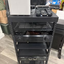 AV Electronics Low Voltage Rack, Yamaha receiver RX-A1050, Panamax M5300-PM, remote controls, subwoofer, Apple TVs, etc.