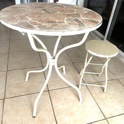 Patio table with a matching stool.