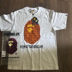 BAPE x MCM white and yellow streetwear tee #BAPE  white, graphic tee, streetwear, bold print, layered, casual, urban style, pop culture, statement pie