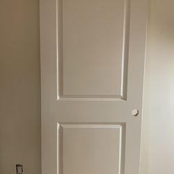 Two panel Roman round top interior door.