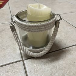 Nautical themed candle holder with line wrapped around the base and the top