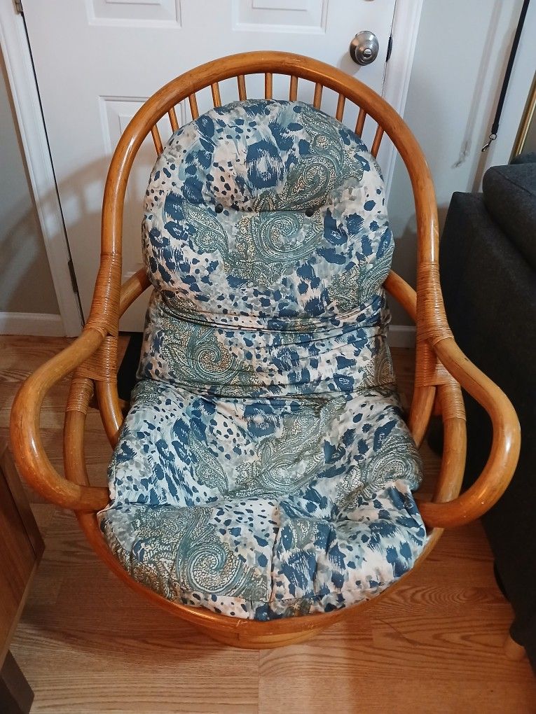 Bamboo Swivel Chair with a patterned cushion and matching ottoman.