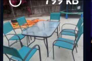 Outdoor glass table with teal chairs
