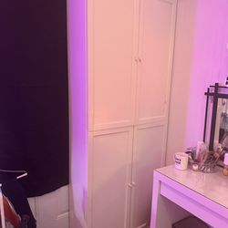 Three white dressers with shelves