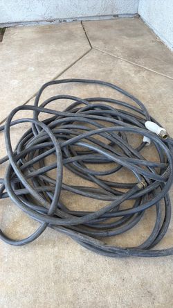 Heavy-duty 50 ft commercial-grade rubber hose in good used condition.