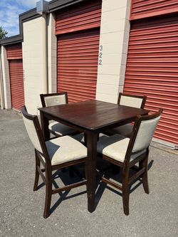 Square wooden high table and four chairs