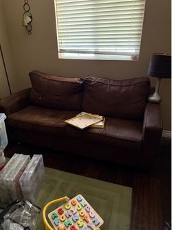 Brown suede loveseat
