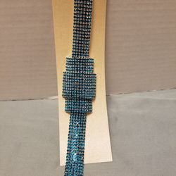 Sparkling bracelet with rows of teal crystals. 