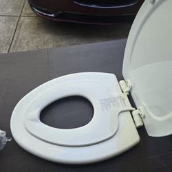 Toilet Seat With Potty Training Seat Attachment.