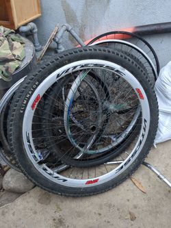 8 assorted bike rims and tires