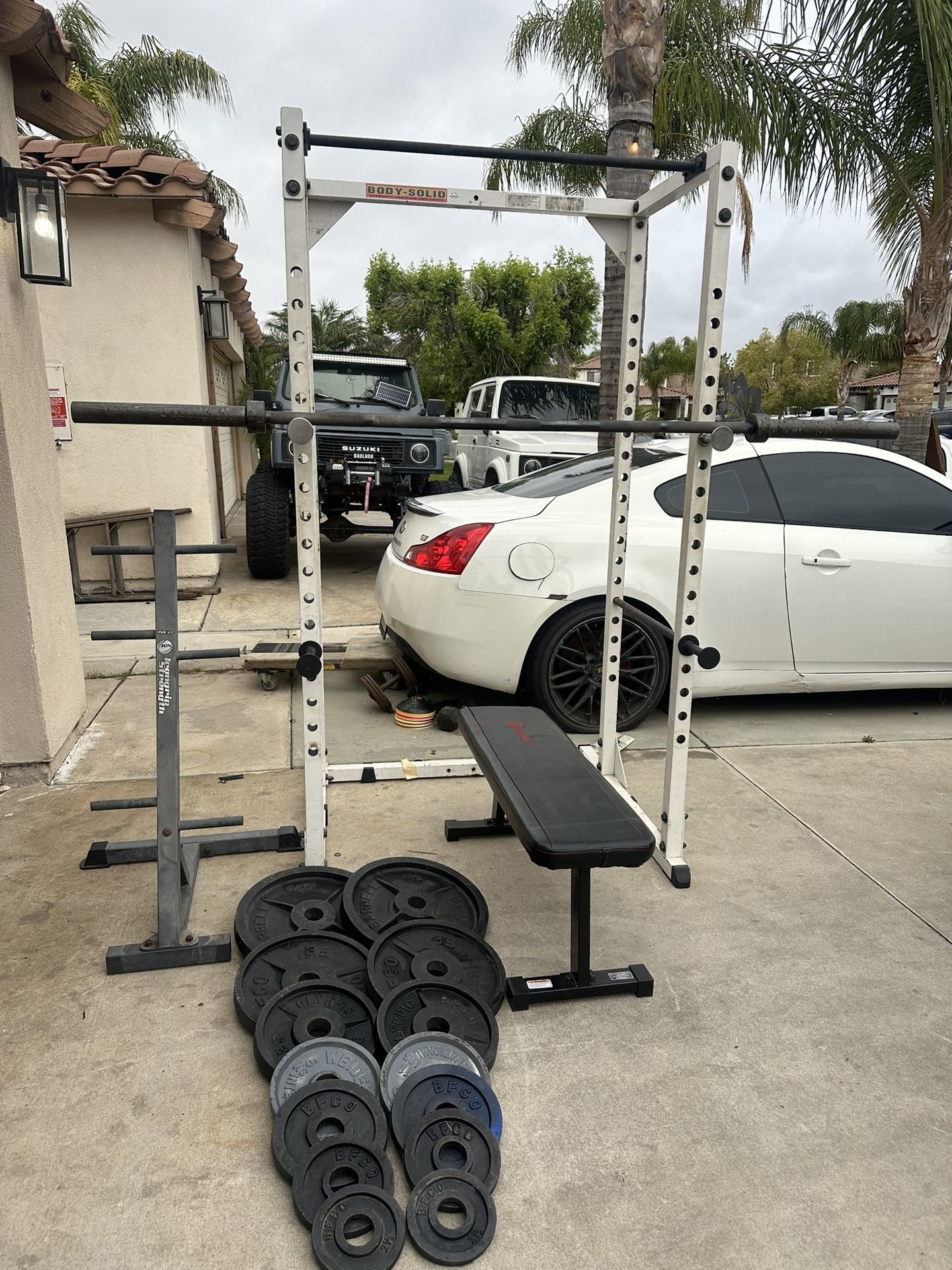 Body solid bench press/squat rack with 267lbs of Olympic weights and 7ft 45lbs bar plus weights tree
