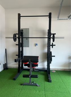Half rack with full weight set and barbell