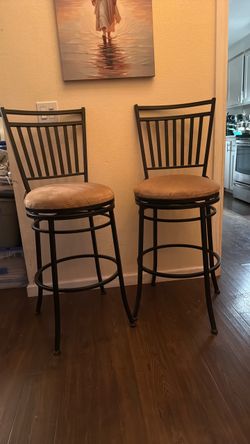 Two tall spinning bar stools