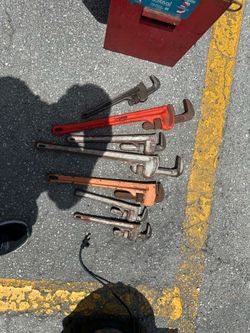 Many large tools rigid pipe wrench