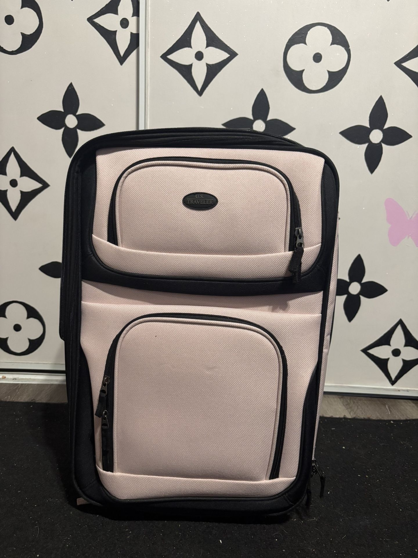 medium pink suitcase and duffle