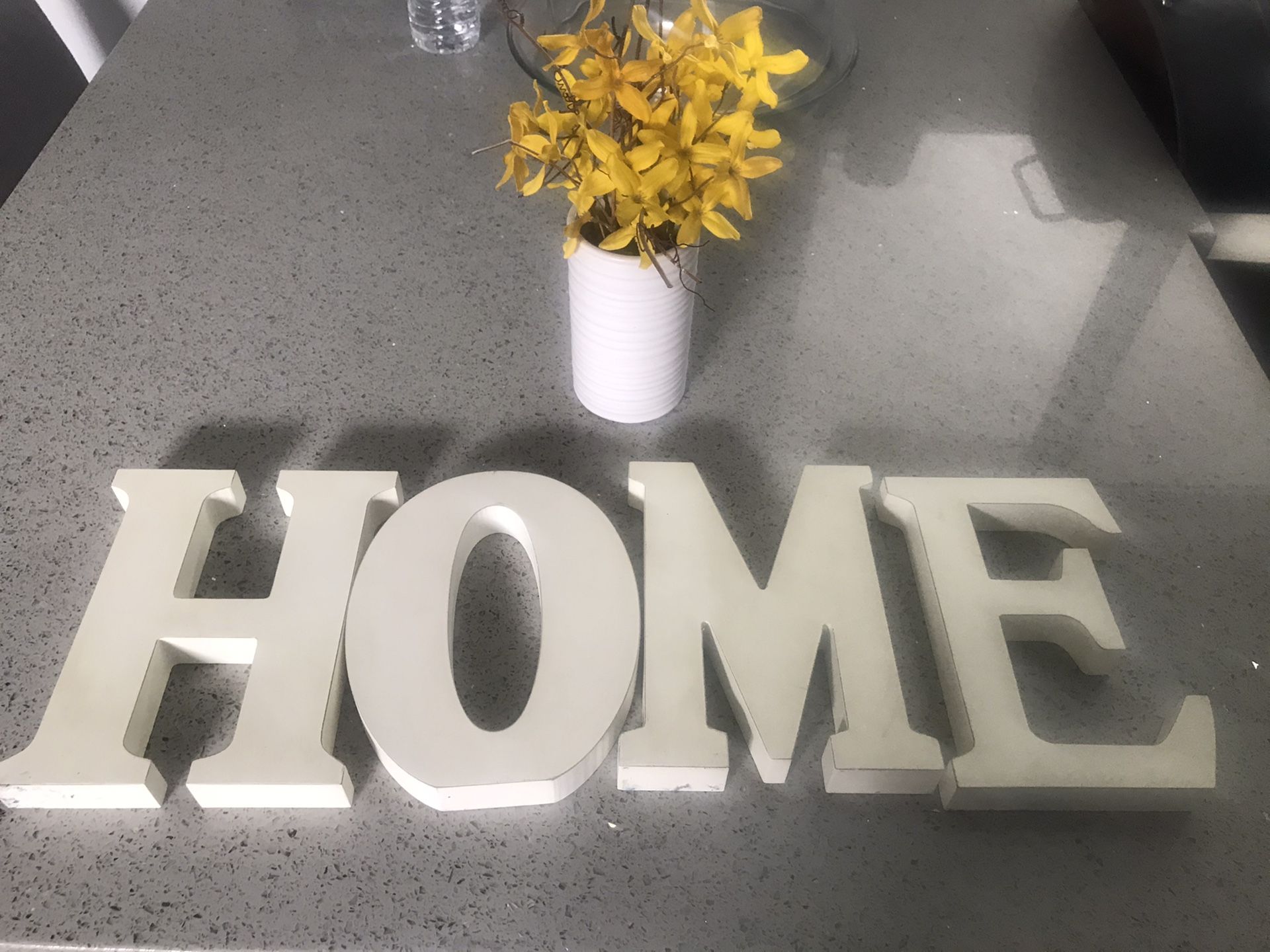 Home sign and fake plant