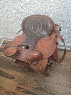 Medium size brown with  several color of brown  horse saddle