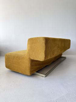 mustard yellow floating sofa with cantilevered backrest