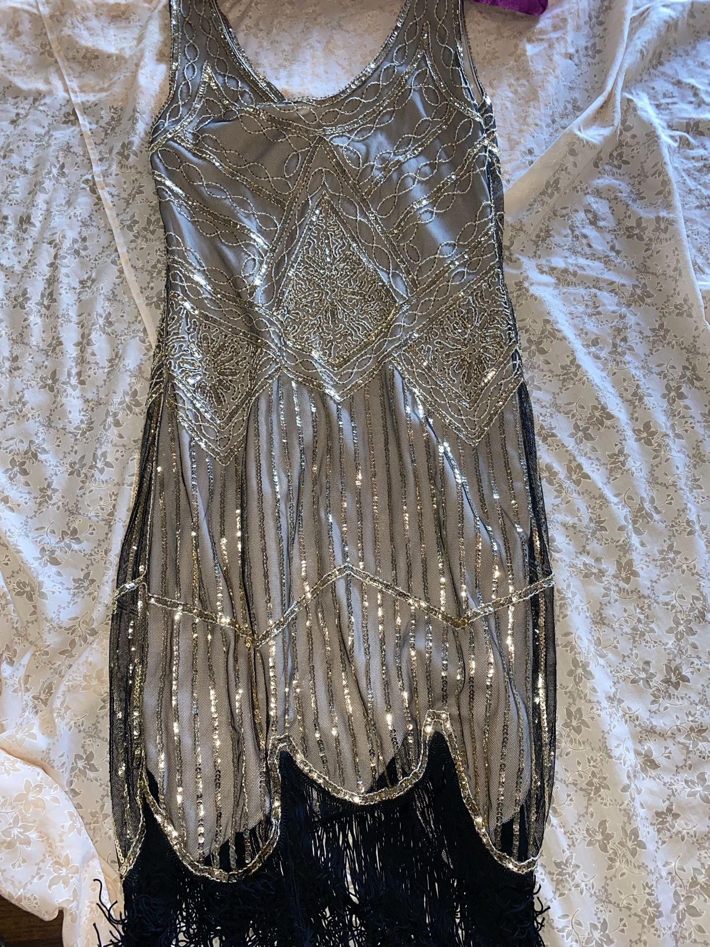 sequined flapper dress, a style iconic of the 1920s.