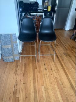 Eames Vitra style molded black plastic and stainless steel counter/bar stools