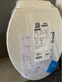 Two new kohler toilet seat covers
