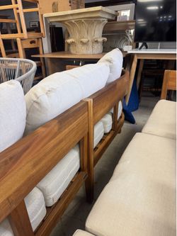 Pair of Safavieh Teak Outdoor Sofas featuring a distinctive wraparound wood frame - Retail: $4400